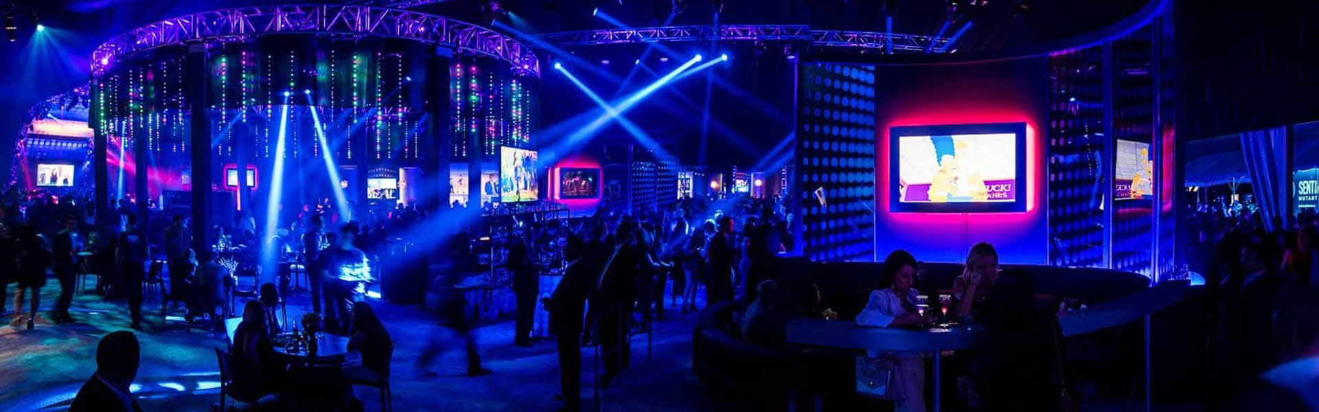 Large indoor catered corporate event with blue lighting